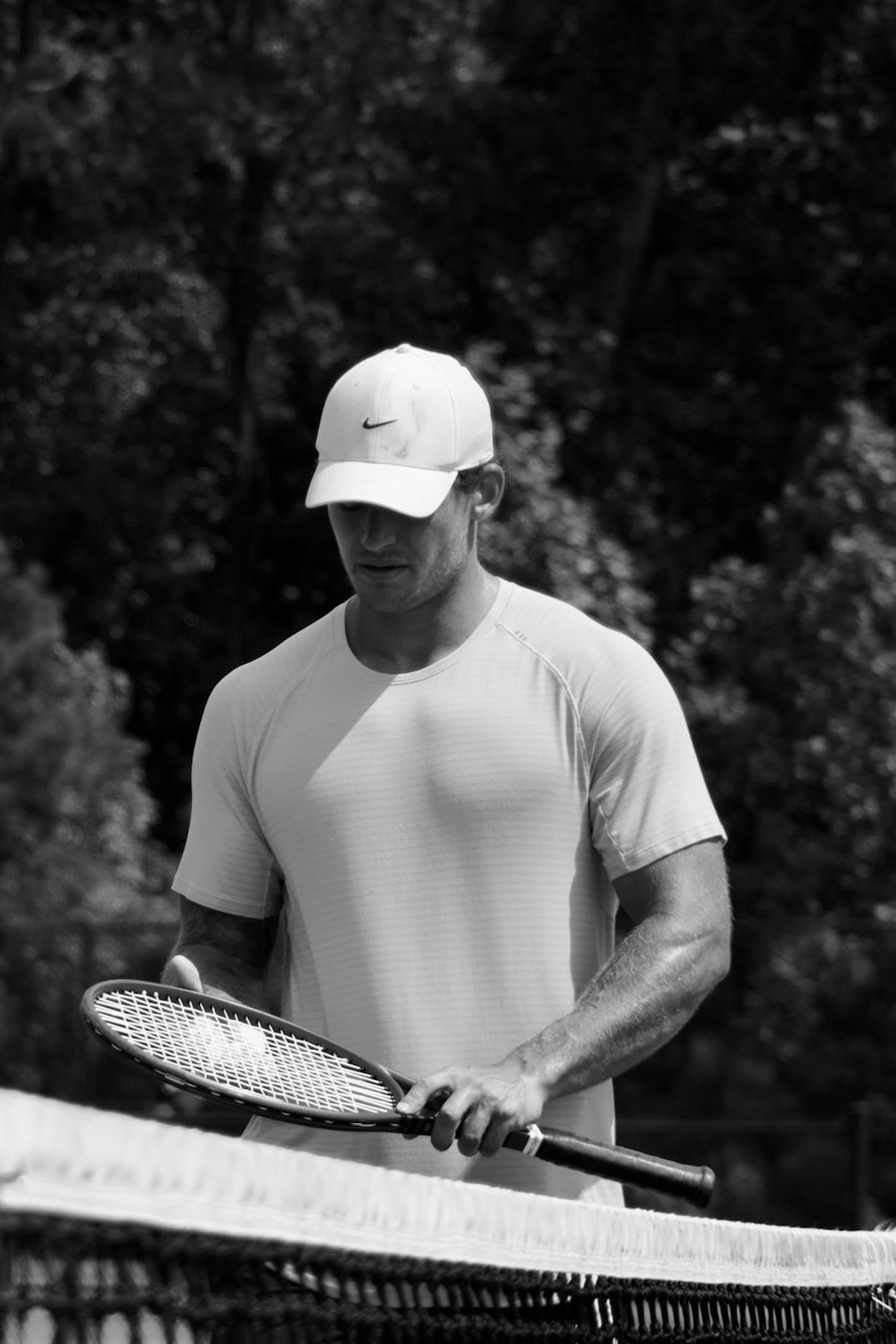 A player in a cap holding a tennis racket